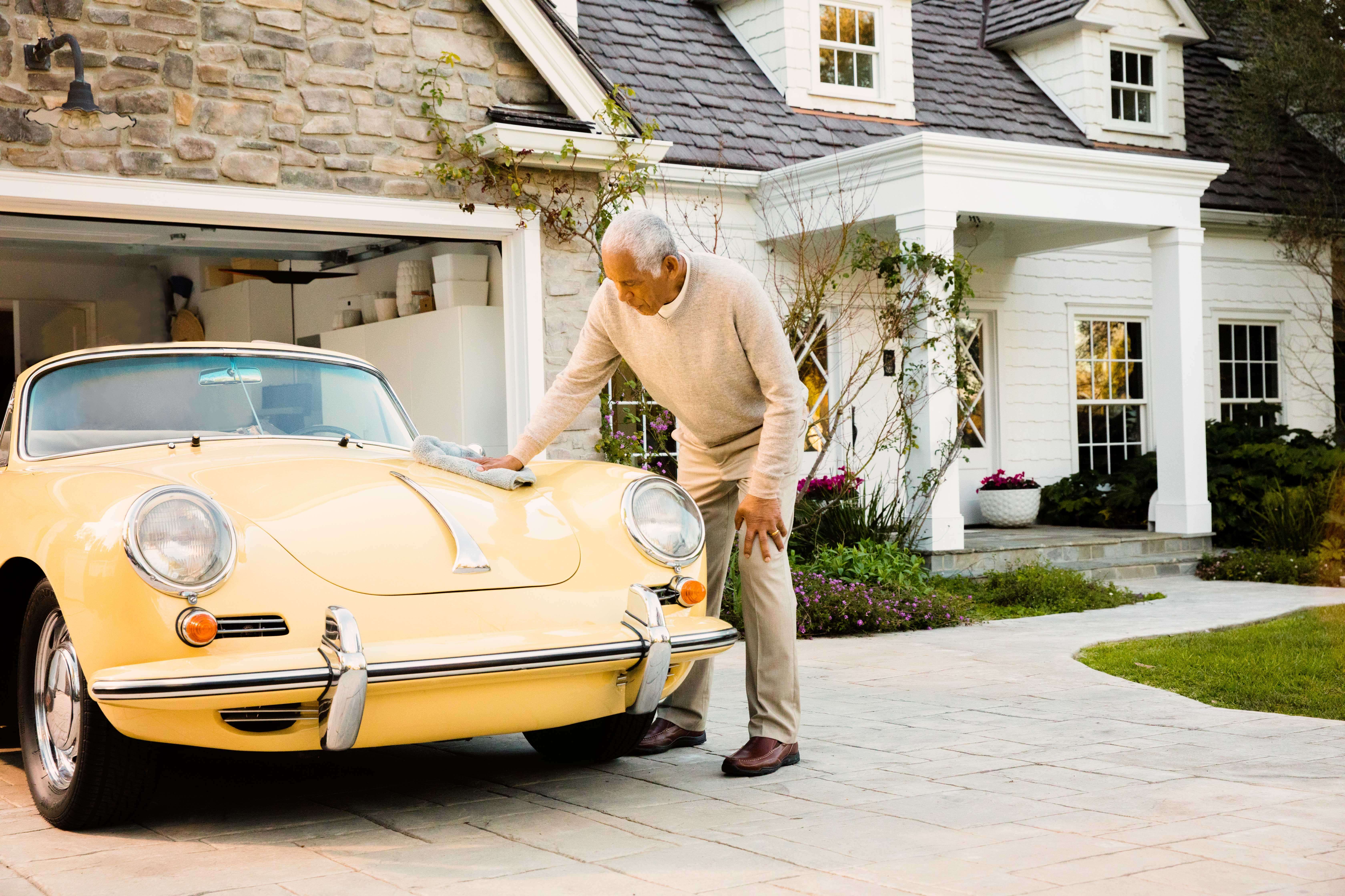Man cleaning classic car